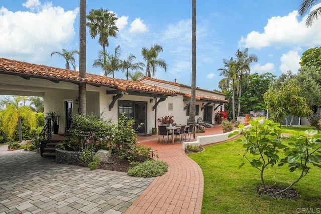 308 Sunset Dr Unit A, Encinitas, CA 92024 - back of house featuring a lawn, stucco siding, a tile roof, and a patio