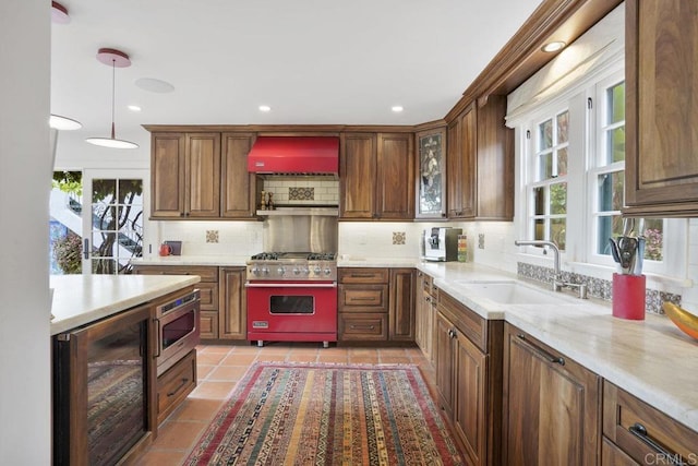 308 Sunset Dr Unit A, Encinitas, CA 92024 - kitchen featuring beverage cooler, appliances with stainless steel finishes, wall chimney exhaust hood, tasteful backsplash, and healthy amount of natural light
