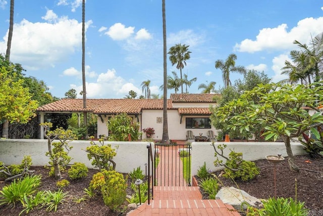 308 Sunset Dr Unit A, Encinitas, CA 92024 - mediterranean / spanish home featuring a fenced front yard, a tile roof, a gate, and stucco siding