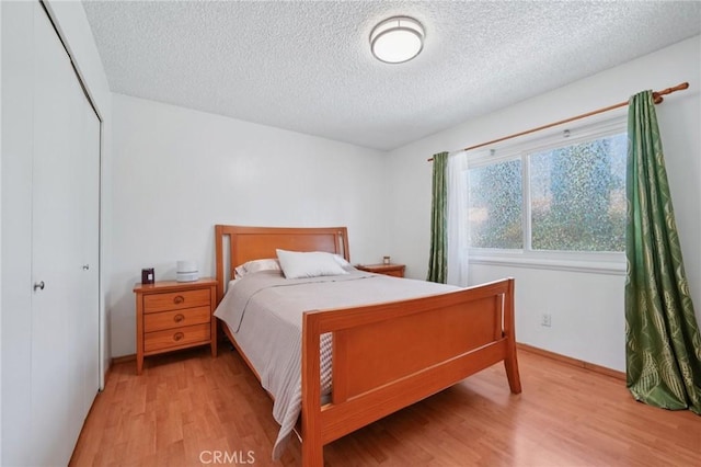 18472 Dragonera Dr, Rowland Heights, CA 91748 - bedroom with a textured ceiling, light wood finished floors, and a closet