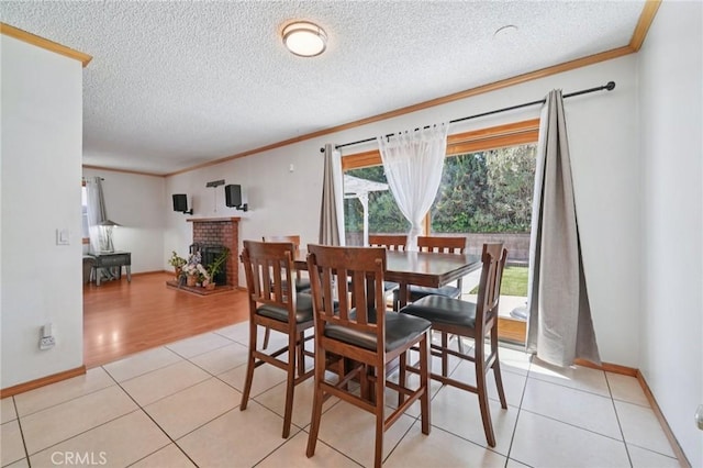 18472 Dragonera Dr, Rowland Heights, CA 91748 - dining area with ornamental molding, a textured ceiling, light tile patterned floors, and a fireplace