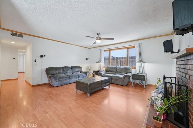 18472 Dragonera Dr, Rowland Heights, CA 91748 - living room with ornamental molding, a ceiling fan, light wood-style flooring, a textured ceiling, and a brick fireplace