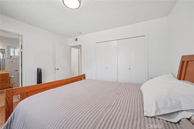 18472 Dragonera Dr, Rowland Heights, CA 91748 - bedroom featuring a closet, a textured ceiling, and ensuite bathroom