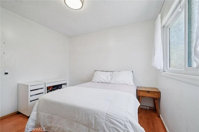18472 Dragonera Dr, Rowland Heights, CA 91748 - bedroom featuring wood finished floors and a textured ceiling