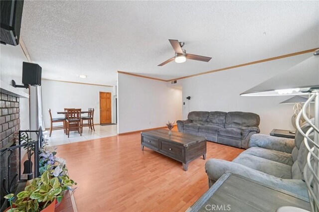 18472 Dragonera Dr, Rowland Heights, CA 91748 - living area with light wood-style floors, a textured ceiling, a ceiling fan, and ornamental molding