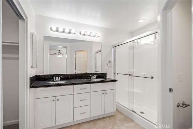 45722 Palm Ln, Lancaster, CA 93535 - bathroom with a shower stall, double vanity, ceiling fan, and a closet