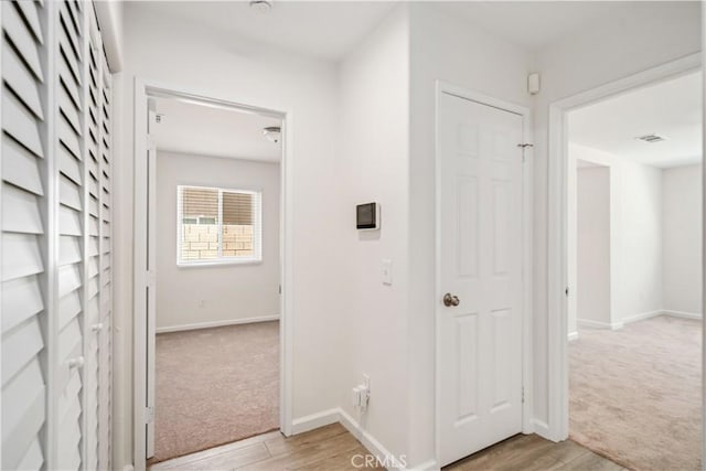45722 Palm Ln, Lancaster, CA 93535 - hall with light carpet and light wood-type flooring