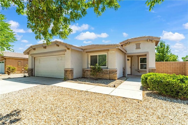 45722 Palm Ln, Lancaster, CA 93535 - view of front of home with stone siding, stucco siding, a garage, concrete driveway, and a tiled roof