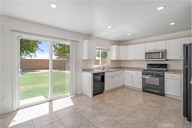 45722 Palm Ln, Lancaster, CA 93535 - kitchen featuring black appliances, white cabinets, light stone counters, recessed lighting, and light tile patterned floors