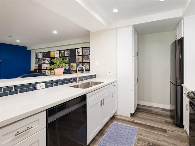 625 Esplanade Unit 29, Redondo Beach, CA 90277 - kitchen with dishwashing machine, freestanding refrigerator, recessed lighting, white cabinets, and wood finished floors