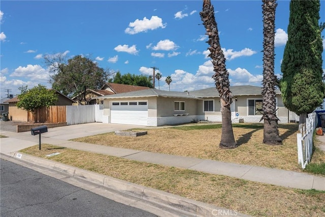 624 N Yucca Ave, Rialto, CA 92376 - ranch-style house with stucco siding, an attached garage, and driveway