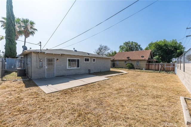 624 N Yucca Ave, Rialto, CA 92376 - back of house featuring a fenced backyard, stucco siding, and a patio area