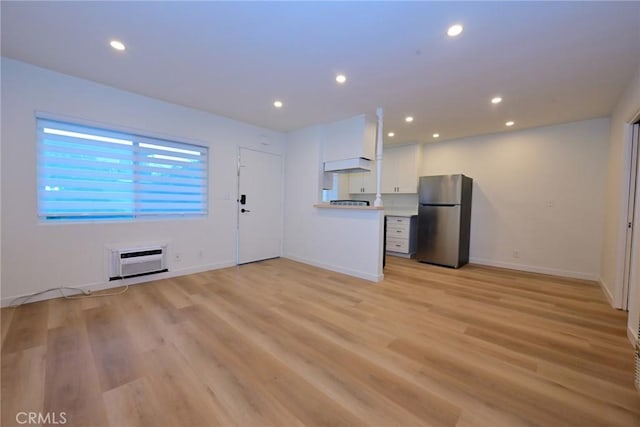 833 W Duarte Rd Unit 11, Arcadia, CA 91007 - unfurnished living room featuring recessed lighting, light wood-style flooring, and a wall unit AC