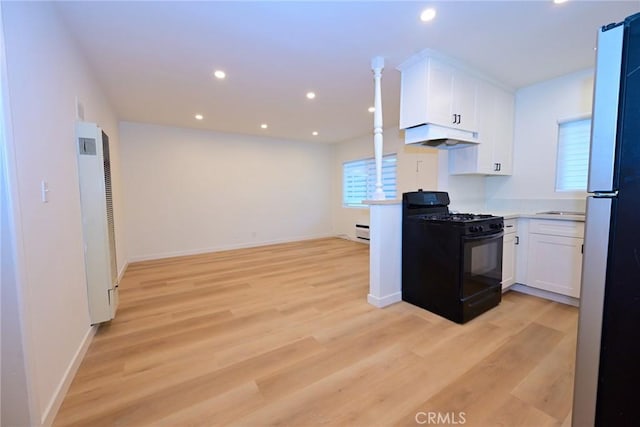 833 W Duarte Rd Unit 11, Arcadia, CA 91007 - kitchen with black range with gas stovetop, under cabinet range hood, a heating unit, white cabinetry, and recessed lighting