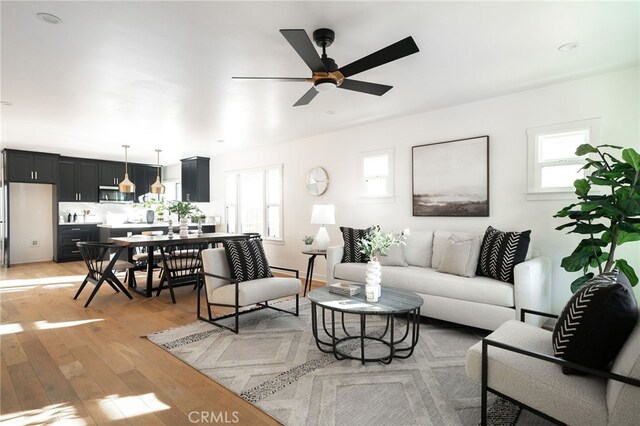2342 S Cochran Ave, Los Angeles, CA 90016 - living room featuring healthy amount of natural light, light wood-style floors, and ceiling fan