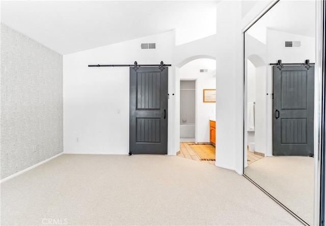 17 Indigo Pl, Aliso Viejo, CA 92656 - unfurnished bedroom with light colored carpet, arched walkways, ensuite bathroom, and high vaulted ceiling