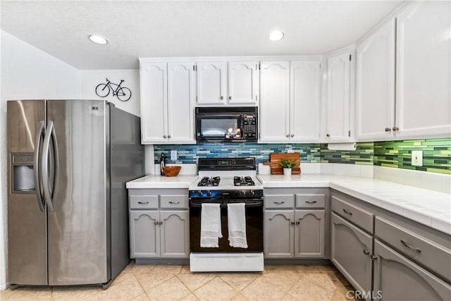 17 Indigo Pl, Aliso Viejo, CA 92656 - kitchen featuring black microwave, gas range, stainless steel fridge with ice dispenser, gray cabinets, and tile countertops