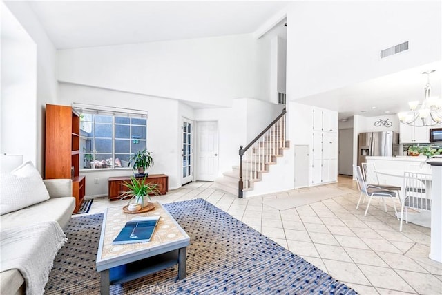 17 Indigo Pl, Aliso Viejo, CA 92656 - living area featuring high vaulted ceiling, stairway, a chandelier, and light tile patterned floors