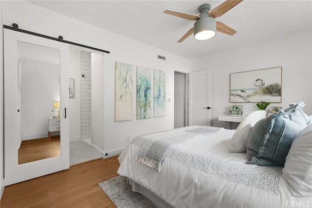 9403 Via Yolanda, Burbank, CA 91504 - bedroom featuring wood finished floors, a barn door, and a ceiling fan