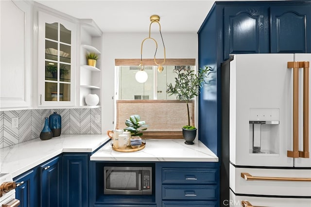 9403 Via Yolanda, Burbank, CA 91504 - kitchen featuring white fridge with ice dispenser, stainless steel microwave, blue cabinetry, backsplash, and glass insert cabinets