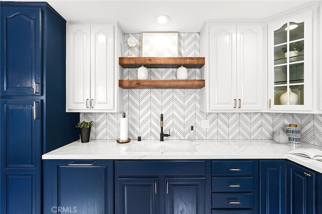 9403 Via Yolanda, Burbank, CA 91504 - kitchen featuring blue cabinets, glass insert cabinets, and backsplash