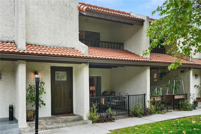 9403 Via Yolanda, Burbank, CA 91504 - rear view of house with a tile roof, stucco siding, and a porch