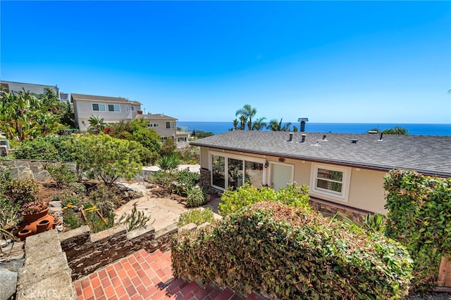 32055 Virginia Way, Laguna Beach, CA 92651 - back of property with a shingled roof, a patio area, and a water view