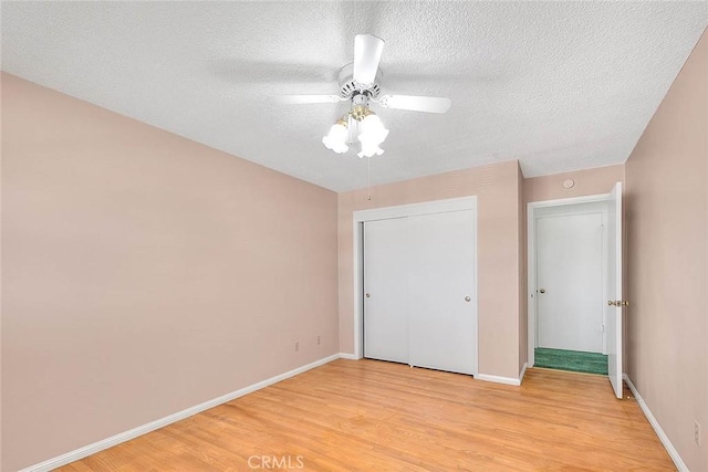 9465 Palo Verde Ave, Fontana, CA 92335 - unfurnished bedroom with light wood-type flooring, a textured ceiling, a closet, and ceiling fan