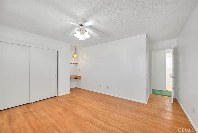 9465 Palo Verde Ave, Fontana, CA 92335 - unfurnished bedroom featuring light wood-type flooring, a textured ceiling, a closet, and ceiling fan