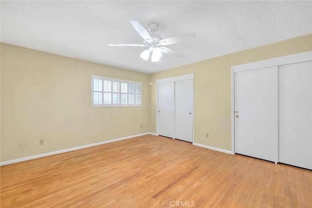 9465 Palo Verde Ave, Fontana, CA 92335 - unfurnished bedroom featuring multiple closets, a textured ceiling, light wood-style floors, and a ceiling fan