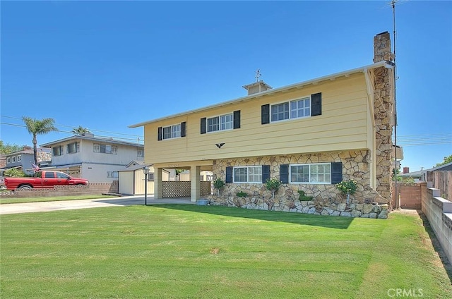 9465 Palo Verde Ave, Fontana, CA 92335 - view of front facade featuring concrete driveway, stone siding, an outbuilding, and a chimney