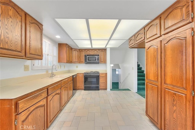 9465 Palo Verde Ave, Fontana, CA 92335 - kitchen with range, stainless steel microwave, dishwashing machine, brown cabinetry, and light countertops