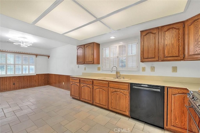 9465 Palo Verde Ave, Fontana, CA 92335 - kitchen with dishwasher, a wainscoted wall, wooden walls, range, and brown cabinetry