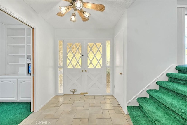 9465 Palo Verde Ave, Fontana, CA 92335 - foyer entrance with a ceiling fan, stairs, and plenty of natural light