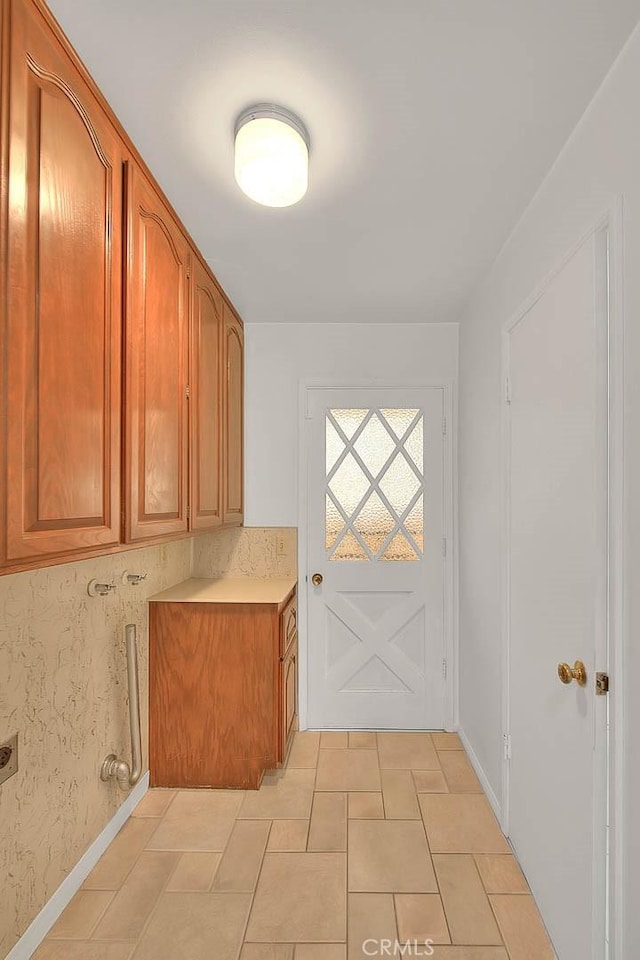 9465 Palo Verde Ave, Fontana, CA 92335 - laundry room with cabinet space, electric dryer hookup, and light tile patterned flooring