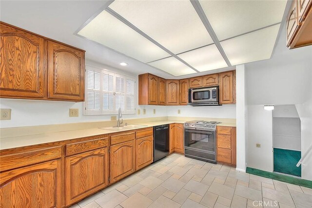 9465 Palo Verde Ave, Fontana, CA 92335 - kitchen with stainless steel microwave, range, dishwasher, brown cabinets, and light countertops