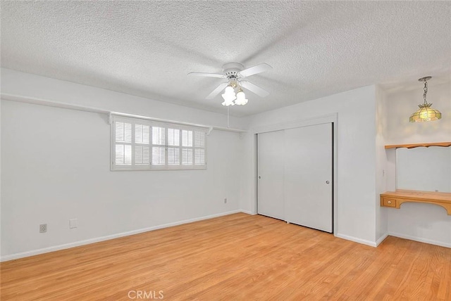 9465 Palo Verde Ave, Fontana, CA 92335 - unfurnished bedroom featuring light wood-style floors, a textured ceiling, ceiling fan, and a closet
