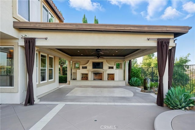 4451 Birdie Dr, Corona, CA 92883 - view of patio featuring exterior fireplace and a ceiling fan