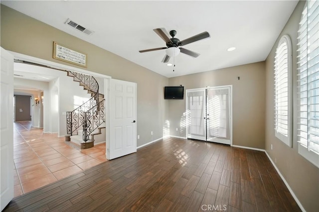 4451 Birdie Dr, Corona, CA 92883 - empty room with a ceiling fan, stairs, and dark wood-style floors