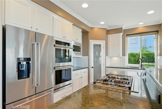4451 Birdie Dr, Corona, CA 92883 - kitchen with appliances with stainless steel finishes, white cabinets, decorative backsplash, recessed lighting, and crown molding