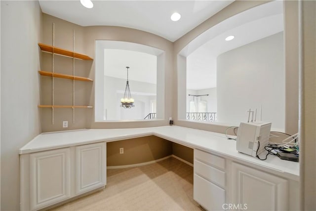 4451 Birdie Dr, Corona, CA 92883 - unfurnished office featuring built in desk, light colored carpet, recessed lighting, and arched walkways