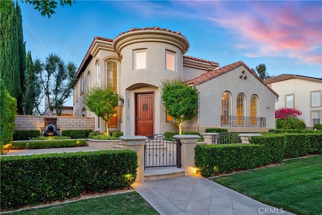 4451 Birdie Dr, Corona, CA 92883 - mediterranean / spanish house featuring a gate, a fenced front yard, stucco siding, and a tile roof