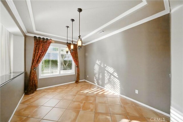 4451 Birdie Dr, Corona, CA 92883 - unfurnished dining area with a raised ceiling, light tile patterned flooring, and crown molding
