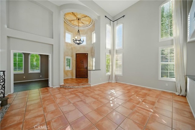 4451 Birdie Dr, Corona, CA 92883 - foyer featuring a high ceiling, plenty of natural light, a chandelier, and tile patterned flooring