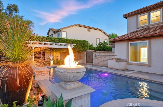 4451 Birdie Dr, Corona, CA 92883 - pool at dusk with a fire pit