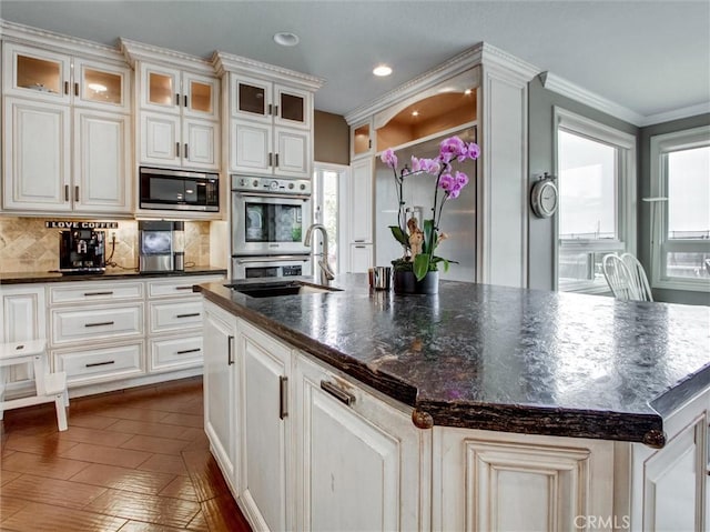 27020 Daisy Cir, Yorba Linda, CA 92887 - kitchen featuring stainless steel appliances, decorative backsplash, a kitchen island with sink, white cabinetry, and recessed lighting