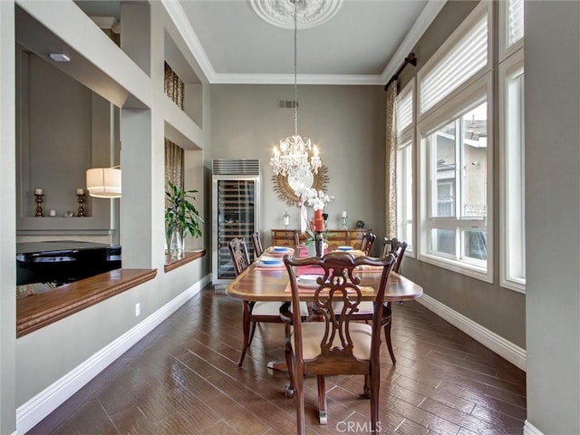 27020 Daisy Cir, Yorba Linda, CA 92887 - dining space with beverage cooler, crown molding, a chandelier, wood finished floors, and a towering ceiling