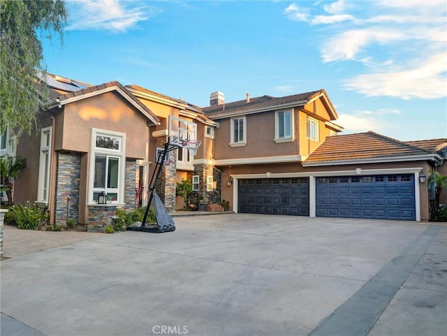 27020 Daisy Cir, Yorba Linda, CA 92887 - view of front of property featuring driveway, stucco siding, stone siding, and a garage