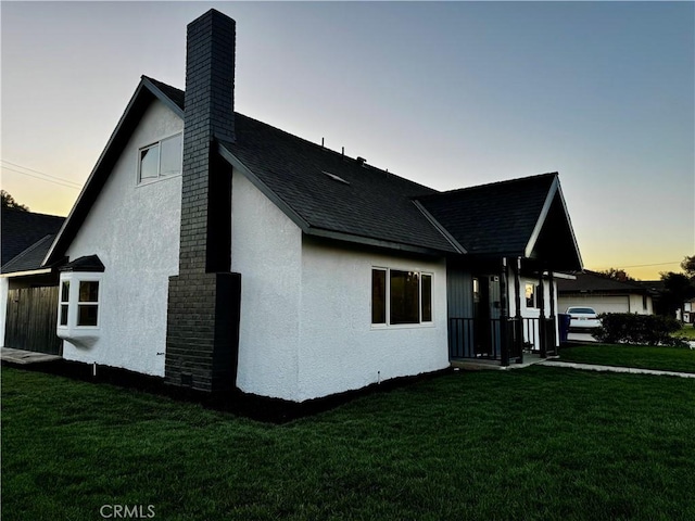 3009 Delburn St, Bakersfield, CA 93304 - view of side of home with a chimney, a yard, stucco siding, and a shingled roof