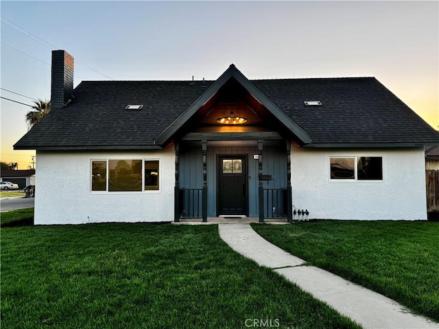 3009 Delburn St, Bakersfield, CA 93304 - view of front of home with a front yard, stucco siding, a chimney, and a shingled roof